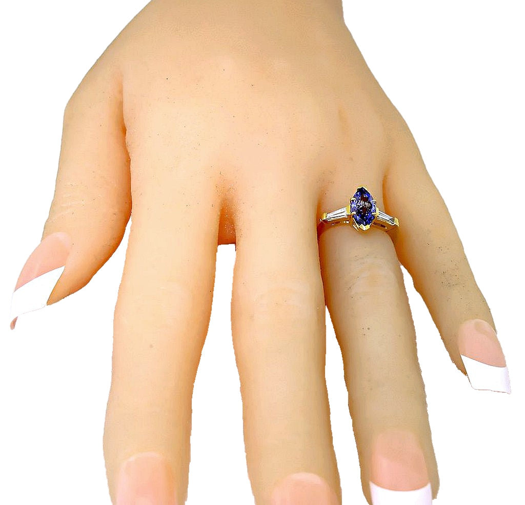 18k yellow gold Marquise Tanzanite and tapered baguette diamond solitaire ring, hand front view