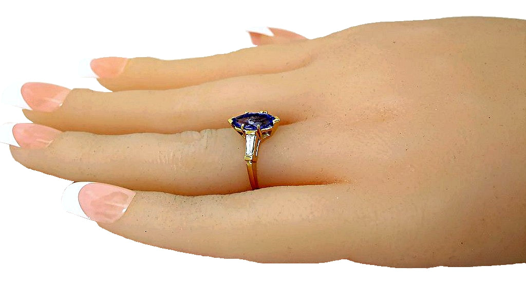 18k yellow gold Marquise Tanzanite and tapered baguette diamond solitaire ring, hand side view