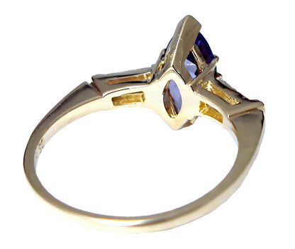 18k yellow gold Marquise Tanzanite and tapered baguette diamond solitaire ring, laying down view