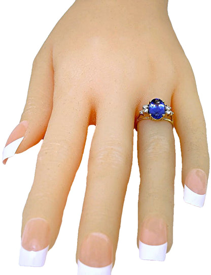 18k yellow gold (elongated) oval Tanzanite and diamond ring front hand view